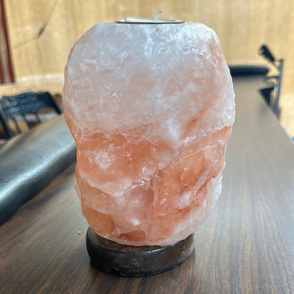 Himalayan salt lamp with candle on top. Wood bottom stand.